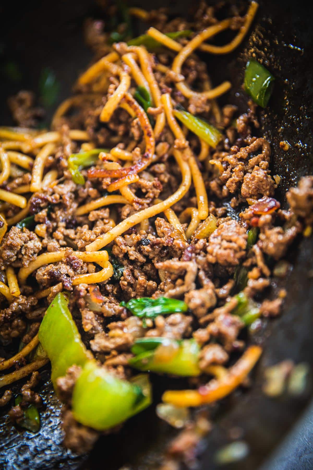Sticky, caramelized beef in a wok full of Hoisin Beef Noodles.